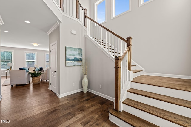 staircase featuring baseboards, recessed lighting, and wood finished floors