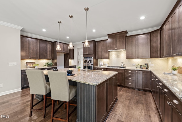 kitchen with ornamental molding, appliances with stainless steel finishes, dark brown cabinetry, and dark wood-style floors