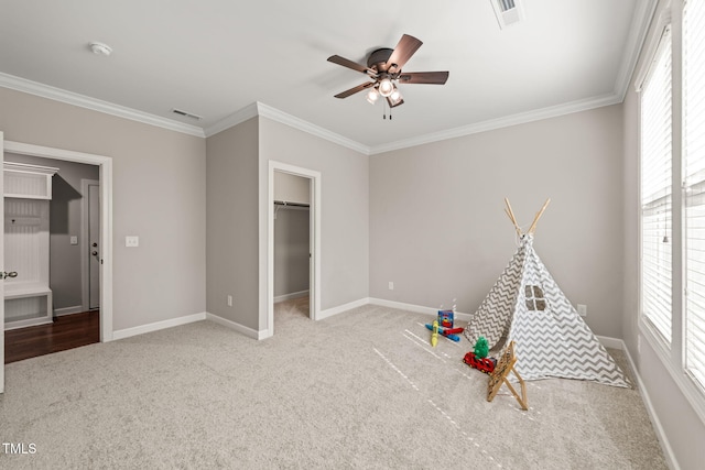 recreation room featuring visible vents, carpet flooring, and ceiling fan