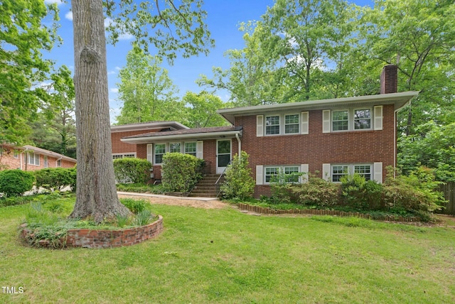 905 Cindy St, Cary, NC 27511 - split level home featuring brick siding, a chimney, and a front yard