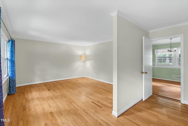 905 Cindy St, Cary, NC 27511 - empty room featuring visible vents, ornamental molding, light wood-style floors, baseboards, and a chandelier