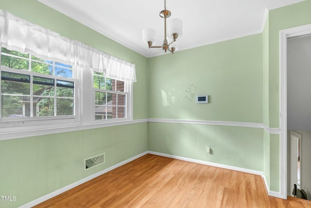 905 Cindy St, Cary, NC 27511 - unfurnished room featuring visible vents, wood finished floors, baseboards, a chandelier, and ornamental molding