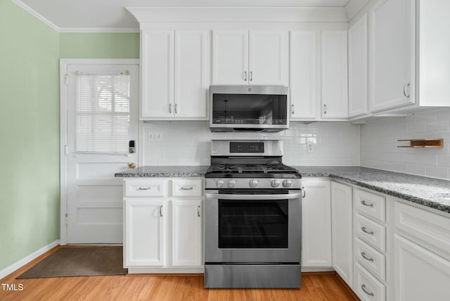 905 Cindy St, Cary, NC 27511 - kitchen featuring white cabinets, stainless steel appliances, baseboards, and light wood-type flooring