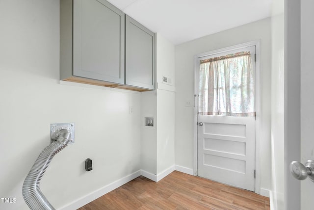 905 Cindy St, Cary, NC 27511 - laundry room with cabinet space, baseboards, visible vents, and light wood-style floors