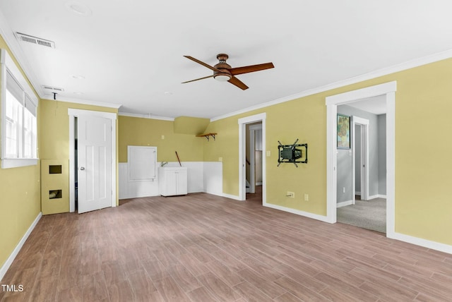 905 Cindy St, Cary, NC 27511 - unfurnished living room featuring ceiling fan, baseboards, wood finished floors, visible vents, and ornamental molding