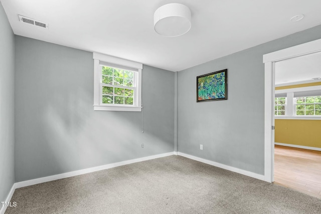 905 Cindy St, Cary, NC 27511 - carpeted spare room with baseboards, visible vents, and a wealth of natural light