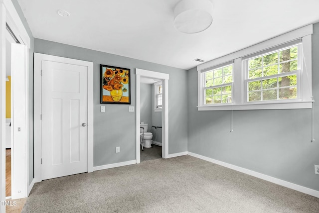 905 Cindy St, Cary, NC 27511 - unfurnished bedroom featuring visible vents, carpet flooring, baseboards, and ensuite bath