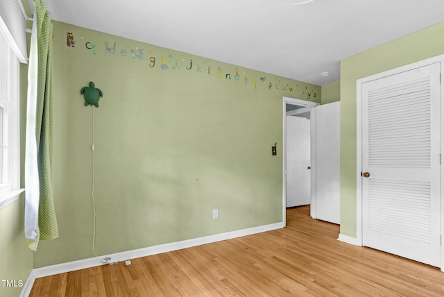 905 Cindy St, Cary, NC 27511 - unfurnished bedroom with baseboards, a closet, and light wood-type flooring