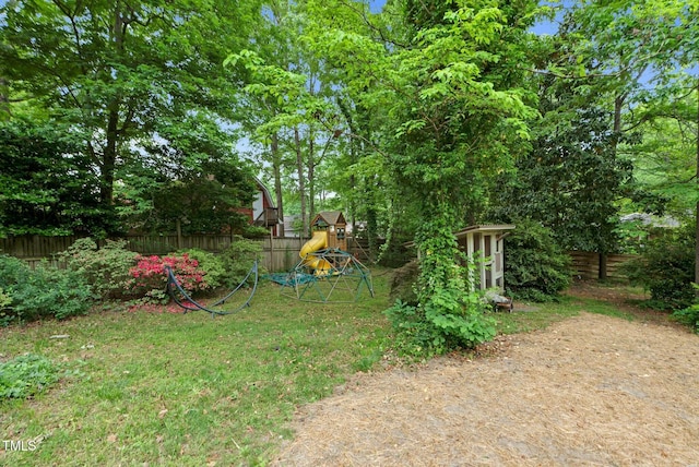 905 Cindy St, Cary, NC 27511 - view of yard with an outdoor structure, a fenced backyard, a playground, and a storage shed
