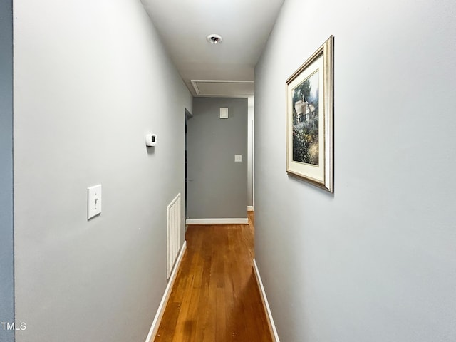 107 N Pearl St, Princeton, NC 27569 - corridor with wood finished floors, baseboards, and attic access