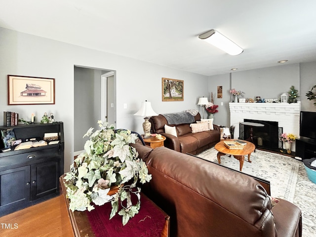 107 N Pearl St, Princeton, NC 27569 - living area featuring light wood-style floors and a brick fireplace