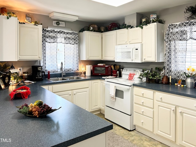 107 N Pearl St, Princeton, NC 27569 - kitchen with white appliances, a sink, dark countertops, and white cabinets