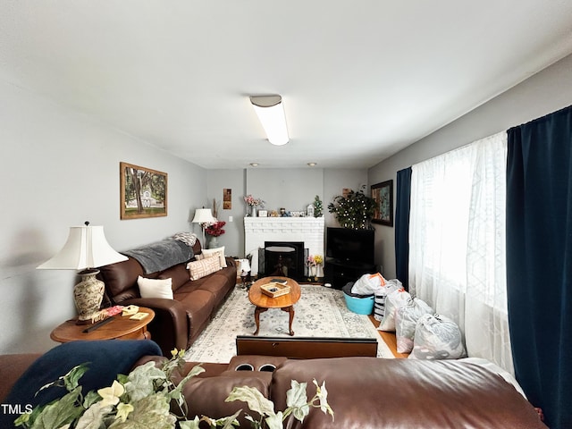 107 N Pearl St, Princeton, NC 27569 - living room with wood finished floors and a brick fireplace
