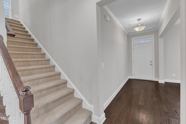 foyer entrance featuring stairway, dark wood-style flooring, baseboards, and ornamental molding