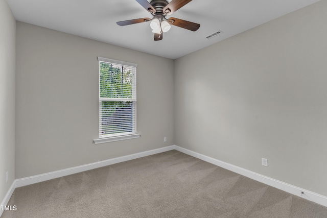 spare room featuring ceiling fan, baseboards, and carpet flooring