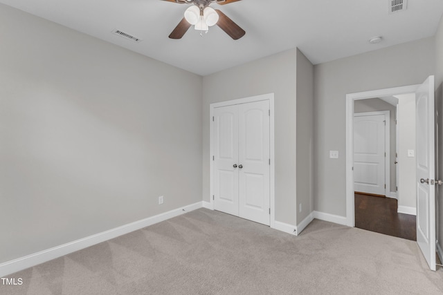 unfurnished bedroom with baseboards, visible vents, carpet floors, and a closet