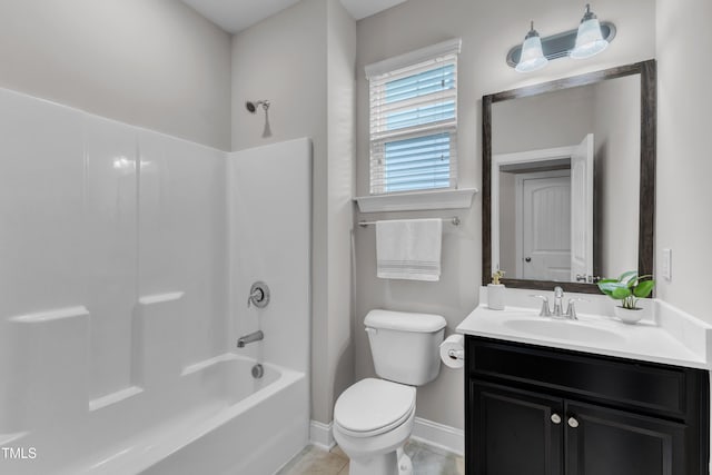 bathroom with baseboards, vanity,  shower combination, and toilet