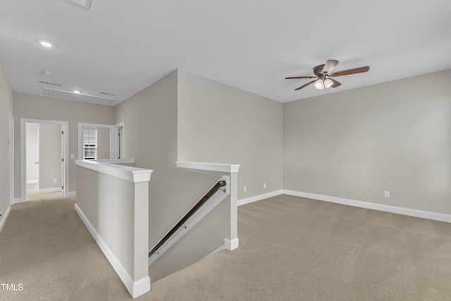 interior space with recessed lighting, baseboards, light colored carpet, and ceiling fan
