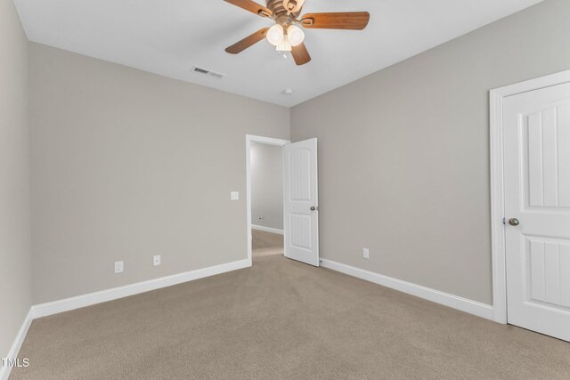 unfurnished bedroom with ceiling fan, baseboards, visible vents, and carpet