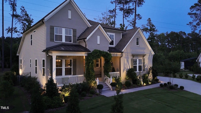 8208 Bella Oak Ct, Wake Forest, NC 27587 - view of front of property featuring a porch, a standing seam roof, a front lawn, metal roof, and a shingled roof