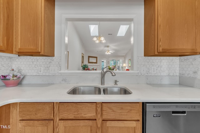 kitchen with decorative backsplash, stainless steel dishwasher, light countertops, and a sink