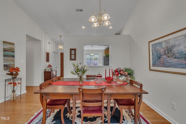 dining room featuring wood finished floors, baseboards, a notable chandelier, visible vents, and recessed lighting