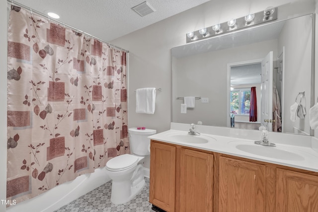 bathroom with tile patterned floors, a sink, double vanity, toilet, and visible vents