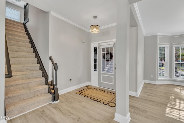 10603 Friendly Neighbor Ln, Raleigh, NC 27614 - entrance foyer with wood finished floors, stairway, baseboards, ornamental molding, and a chandelier