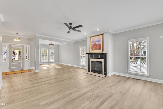 10603 Friendly Neighbor Ln, Raleigh, NC 27614 - unfurnished living room featuring light wood-type flooring, baseboards, a glass covered fireplace, crown molding, and ceiling fan
