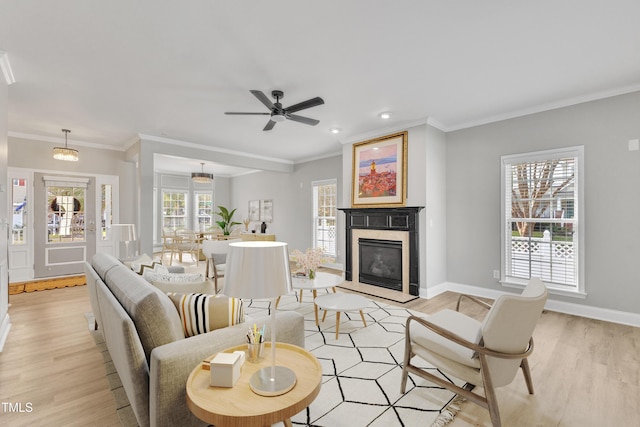 10603 Friendly Neighbor Ln, Raleigh, NC 27614 - living area featuring light wood-style flooring, a premium fireplace, baseboards, recessed lighting, and ornamental molding