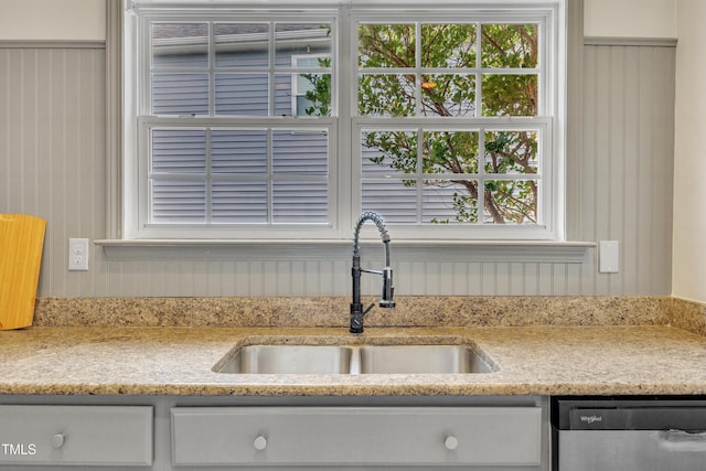 10603 Friendly Neighbor Ln, Raleigh, NC 27614 - kitchen featuring stainless steel dishwasher, a sink, healthy amount of natural light, and white cabinets