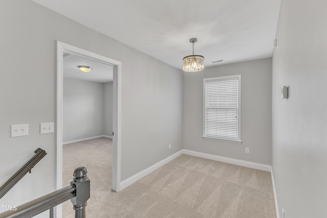 10603 Friendly Neighbor Ln, Raleigh, NC 27614 - empty room with carpet floors, baseboards, and a chandelier
