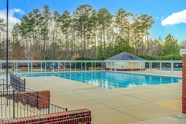 10603 Friendly Neighbor Ln, Raleigh, NC 27614 - community pool with a patio area and view of scattered trees