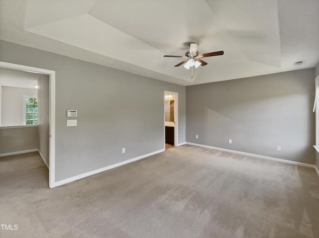 10 Sandy Bluff Ct, Durham, NC 27703 - spare room with ceiling fan, carpet floors, baseboards, and a raised ceiling