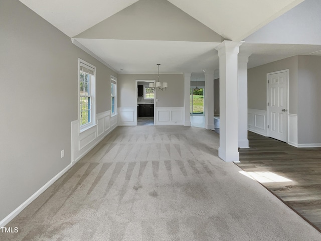 10 Sandy Bluff Ct, Durham, NC 27703 - unfurnished living room featuring a decorative wall, wainscoting, light carpet, and decorative columns