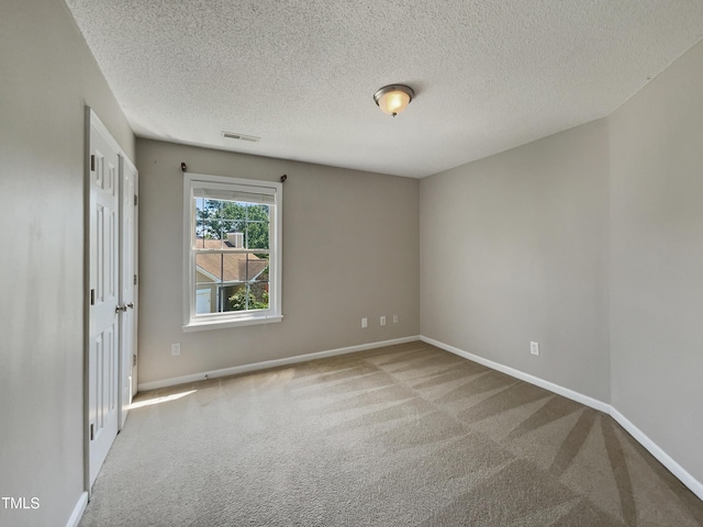 10 Sandy Bluff Ct, Durham, NC 27703 - carpeted spare room with a textured ceiling, baseboards, and visible vents