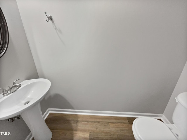 10 Sandy Bluff Ct, Durham, NC 27703 - half bathroom featuring baseboards, wood finished floors, and toilet