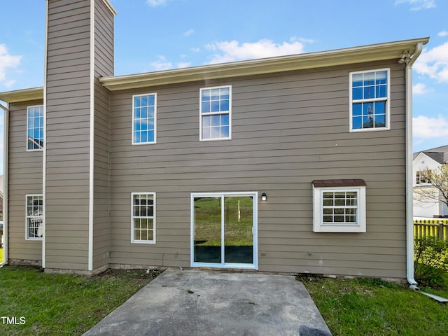 10 Sandy Bluff Ct, Durham, NC 27703 - back of property with a chimney and a patio