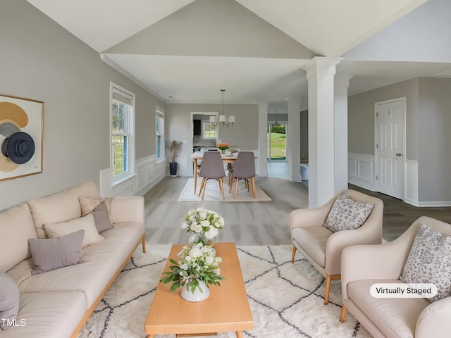 10 Sandy Bluff Ct, Durham, NC 27703 - living area with vaulted ceiling, a decorative wall, wood finished floors, wainscoting, and ornate columns