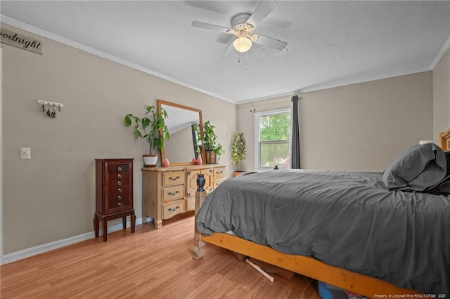 bedroom featuring ornamental molding, light wood finished floors, baseboards, a ceiling fan, and a textured ceiling