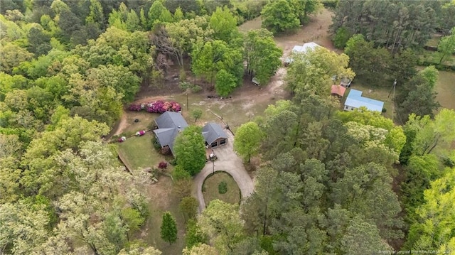 aerial view of property's location featuring a heavily wooded area