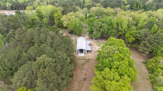 view from above of property with a heavily wooded area