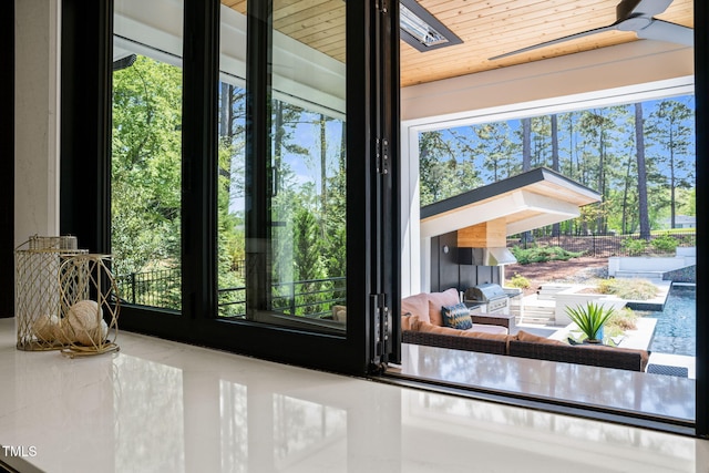 doorway featuring plenty of natural light, wood ceiling, and tile patterned flooring