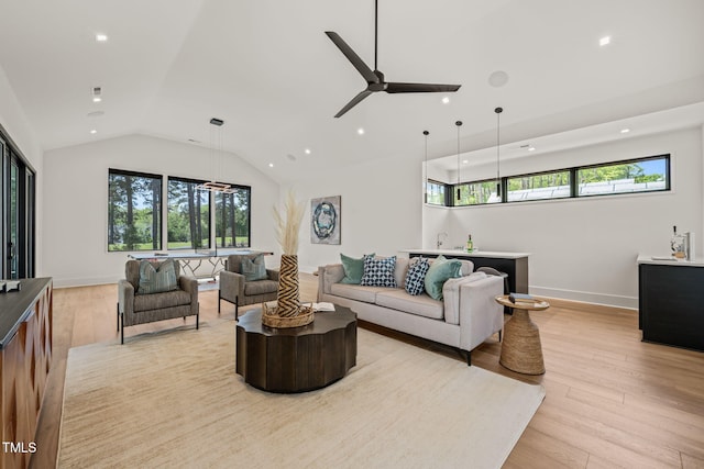 living area with light wood-style floors, ceiling fan, recessed lighting, and lofted ceiling