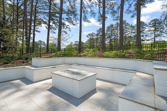 view of patio featuring a fenced backyard and a fire pit