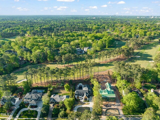bird's eye view with a wooded view