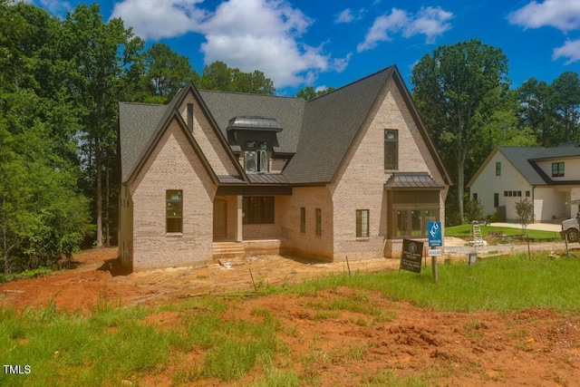 2305 Ballywater Lea Way, Wake Forest, NC 27587 - rear view of property featuring a standing seam roof, brick siding, and a metal roof