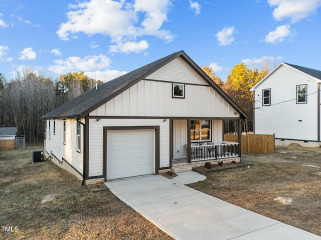 view of front facade featuring covered porch, board and batten siding, a garage, central AC, and fence