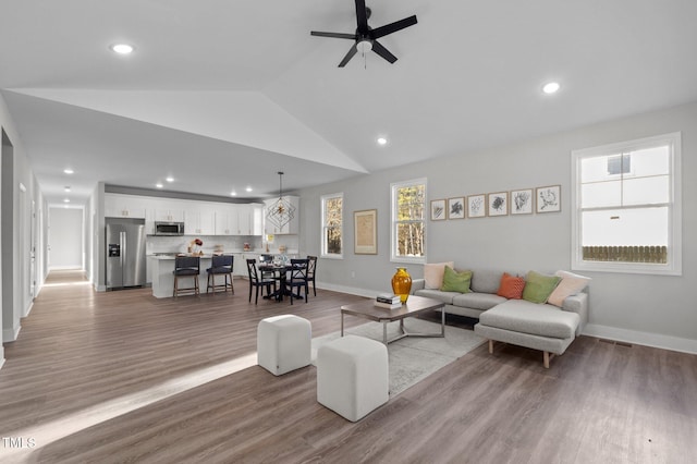 living area with baseboards, a ceiling fan, and recessed lighting