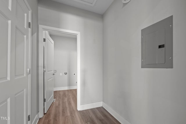 hall with baseboards, electric panel, and dark wood-type flooring